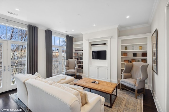 living room with french doors, crown molding, and dark wood-type flooring