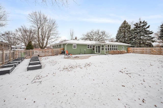 view of snow covered rear of property