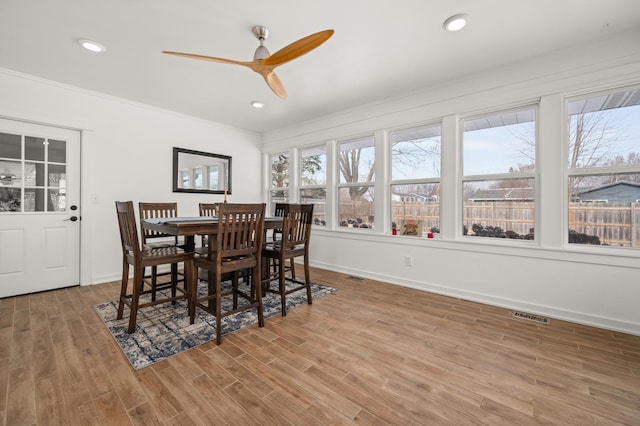 dining area featuring ceiling fan, crown molding, and wood-type flooring