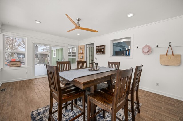 dining area featuring crown molding, dark hardwood / wood-style floors, and ceiling fan