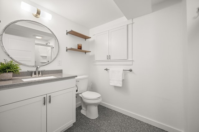 bathroom featuring vanity, toilet, and walk in shower