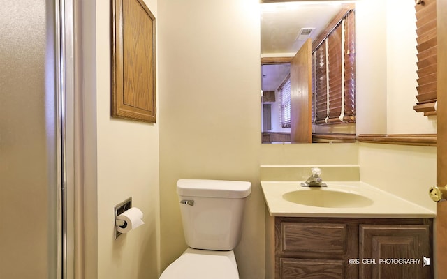 bathroom featuring vanity and toilet