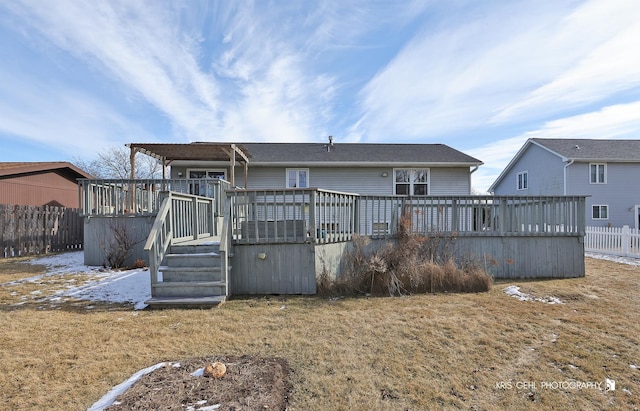 rear view of house featuring a yard and a deck