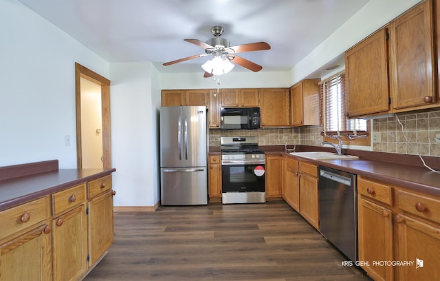 kitchen featuring sink, ceiling fan, stainless steel appliances, dark hardwood / wood-style floors, and tasteful backsplash