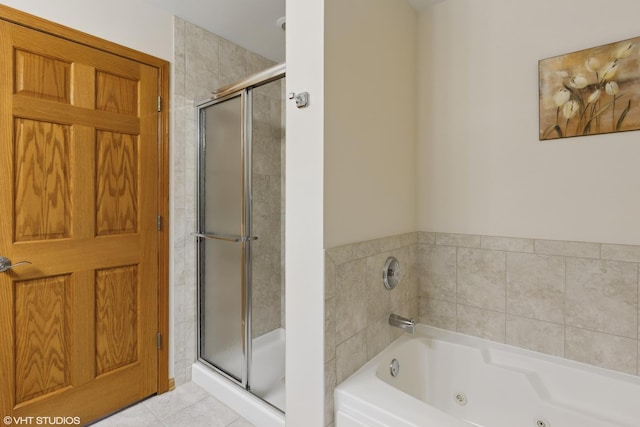 bathroom with separate shower and tub and tile patterned flooring