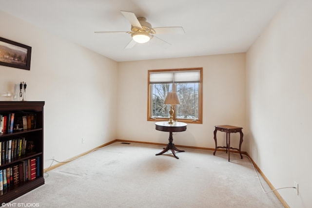 interior space with ceiling fan and carpet