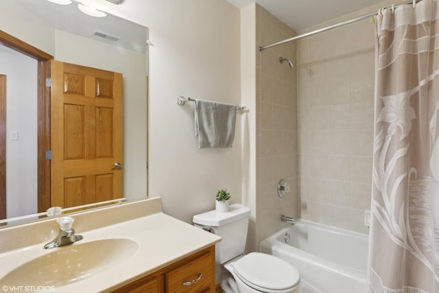 full bathroom with vanity, shower / bath combination with curtain, and toilet