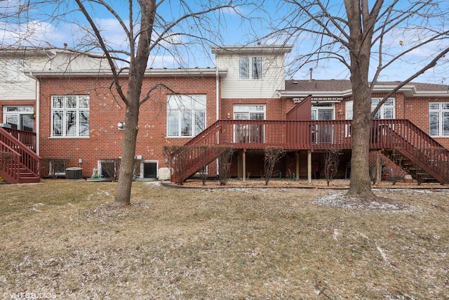 rear view of property featuring a wooden deck, a yard, and cooling unit