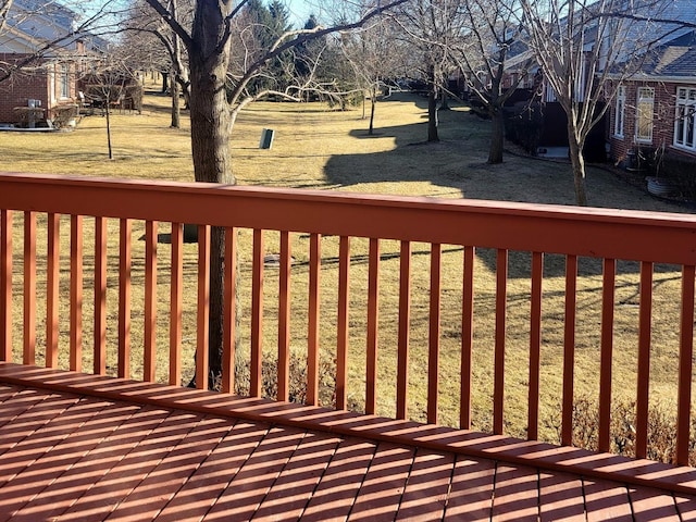 wooden terrace featuring a yard