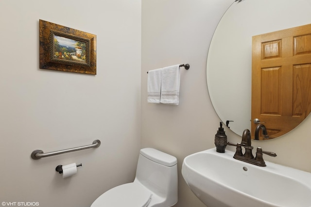 bathroom featuring sink and toilet