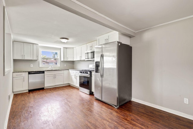 kitchen featuring appliances with stainless steel finishes, sink, white cabinets, crown molding, and dark wood-type flooring