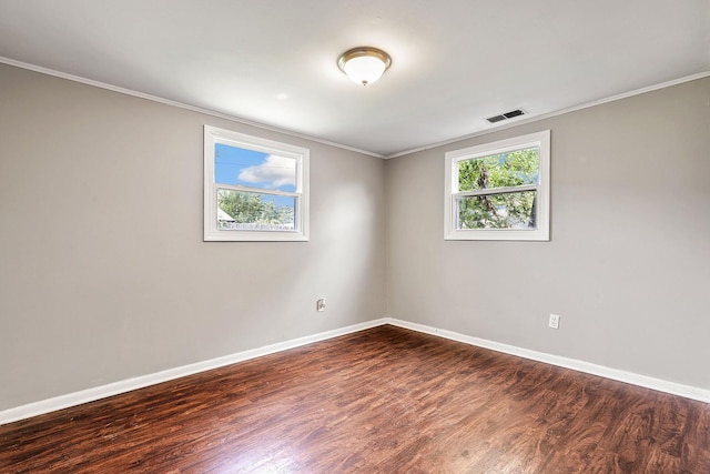 unfurnished room with crown molding and dark wood-type flooring