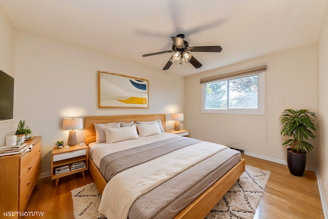 bedroom with light hardwood / wood-style flooring and ceiling fan