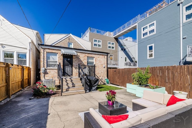 exterior space with a patio, an outdoor hangout area, and central AC