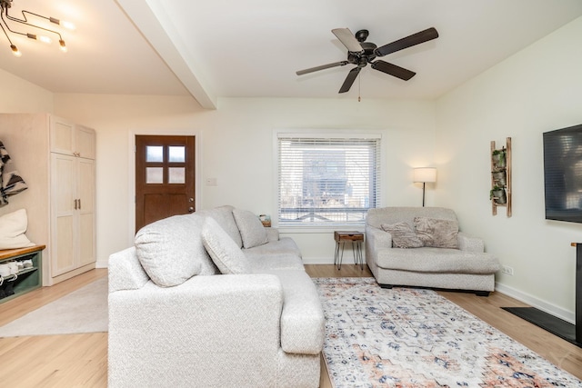 living room featuring ceiling fan, beam ceiling, and light hardwood / wood-style flooring