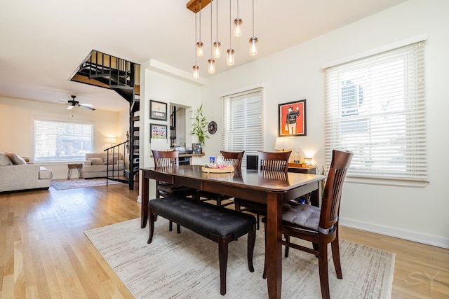 dining room with hardwood / wood-style flooring and ceiling fan