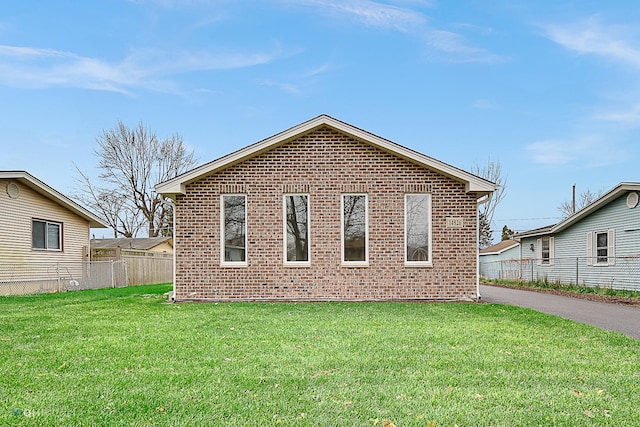 view of side of property with a yard