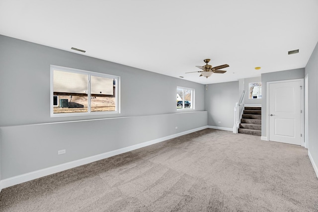 unfurnished living room featuring carpet flooring and ceiling fan