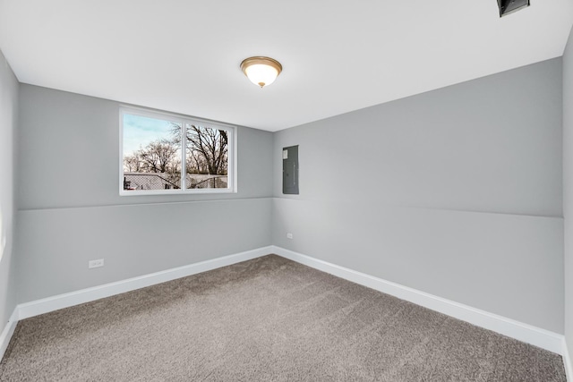 unfurnished room featuring electric panel and carpet flooring