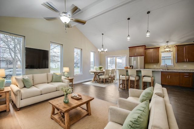 living room with plenty of natural light, dark hardwood / wood-style flooring, sink, and beam ceiling