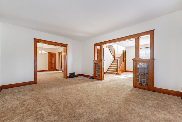 empty room with stairs, carpet, and baseboards