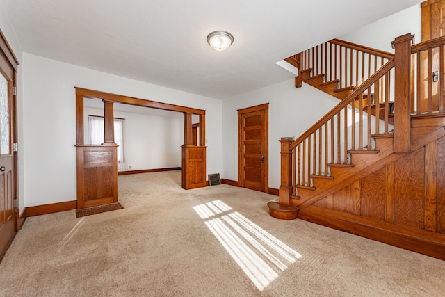 entrance foyer featuring stairway, carpet, visible vents, and baseboards