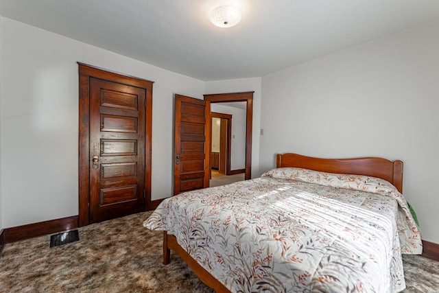 carpeted bedroom featuring visible vents and baseboards