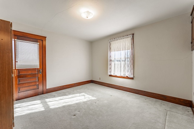 empty room with carpet and baseboards