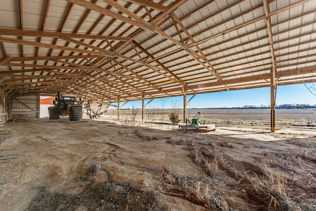 miscellaneous room with vaulted ceiling and a rural view