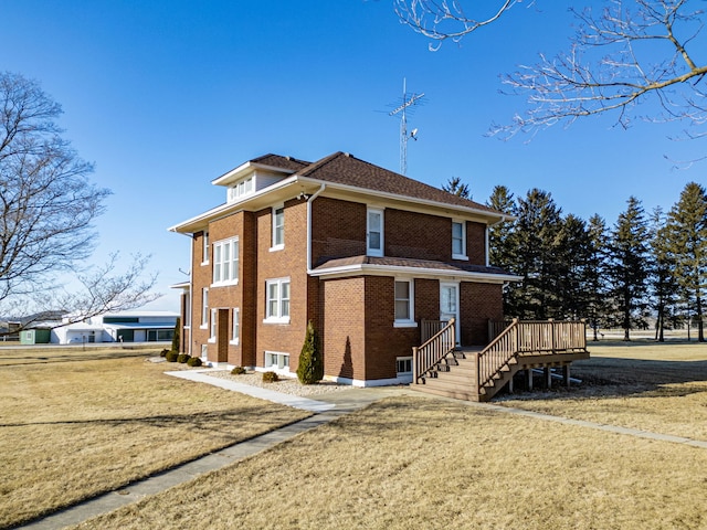 view of property exterior with brick siding and a lawn