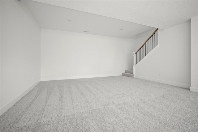 empty room with carpet and a textured ceiling