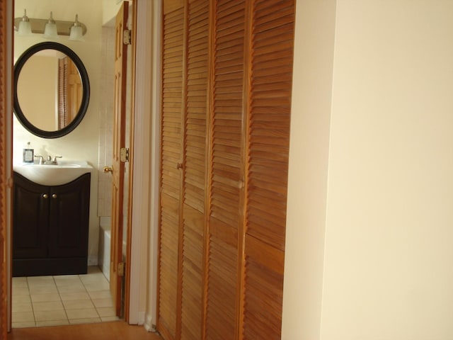 hall with sink and light tile patterned flooring