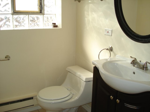 bathroom with vanity, toilet, tile patterned floors, and baseboard heating