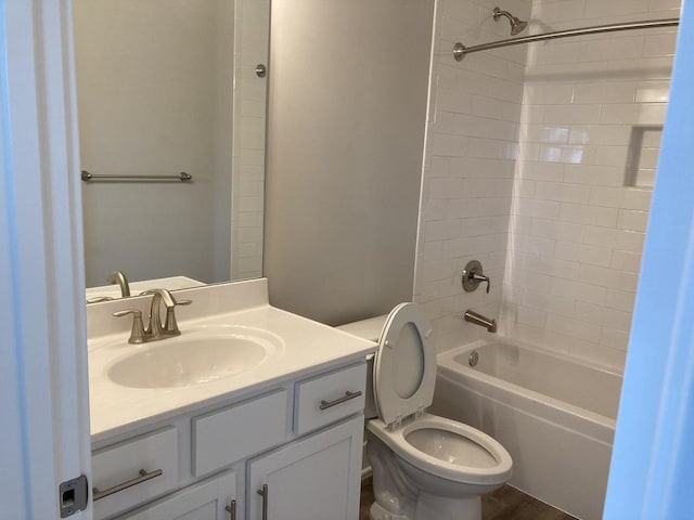 full bathroom with wood-type flooring, toilet, washtub / shower combination, and vanity