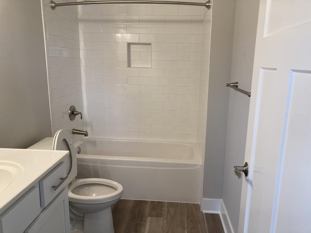 full bathroom with vanity, toilet, tiled shower / bath, and wood-type flooring