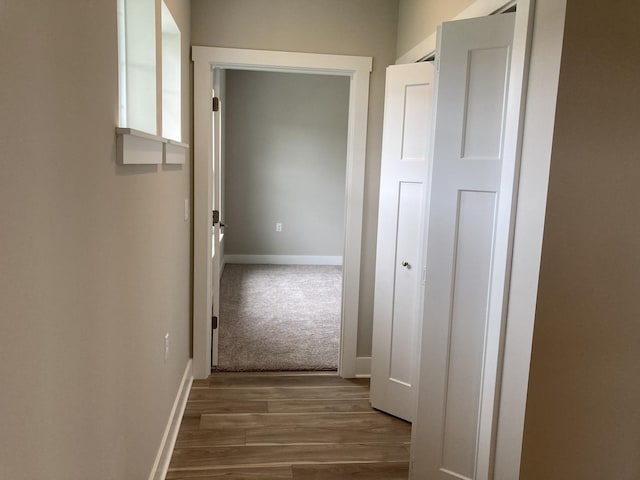 corridor with dark hardwood / wood-style floors