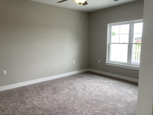 carpeted empty room featuring ceiling fan and a wealth of natural light