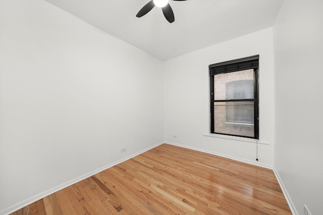 spare room featuring hardwood / wood-style flooring and ceiling fan