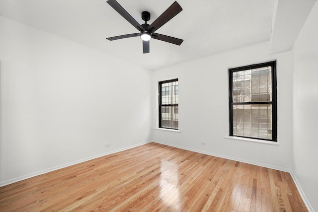 unfurnished room featuring ceiling fan and light hardwood / wood-style floors