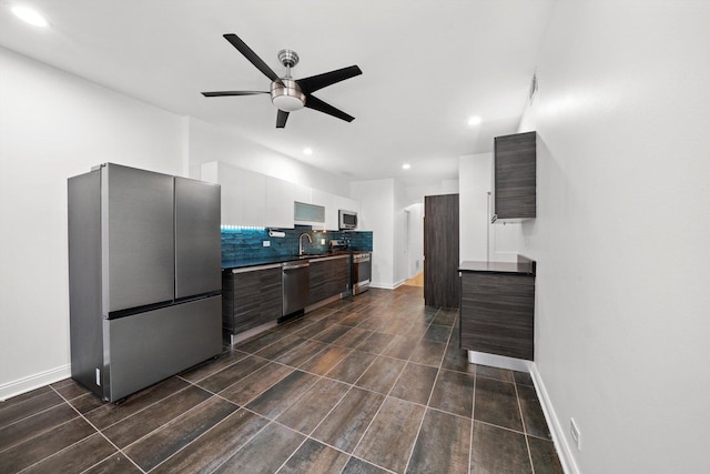 kitchen with dark brown cabinetry, sink, white cabinetry, appliances with stainless steel finishes, and ceiling fan