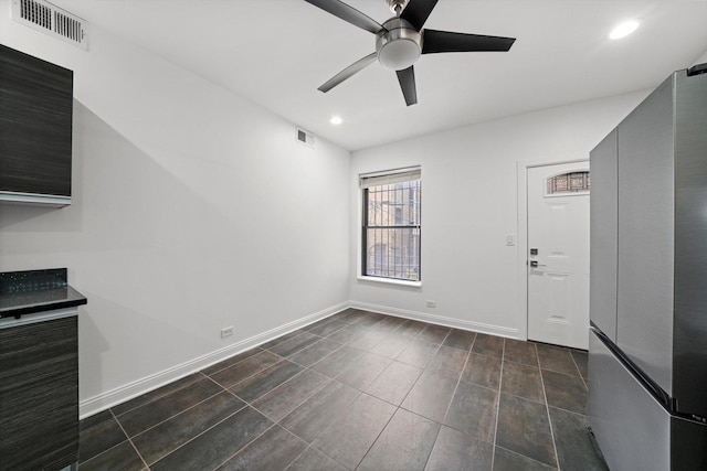 unfurnished living room featuring ceiling fan