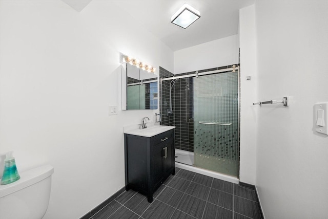 bathroom with vanity, an enclosed shower, and toilet