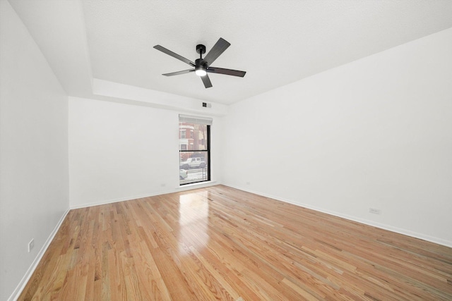 spare room featuring a textured ceiling, light hardwood / wood-style floors, and ceiling fan