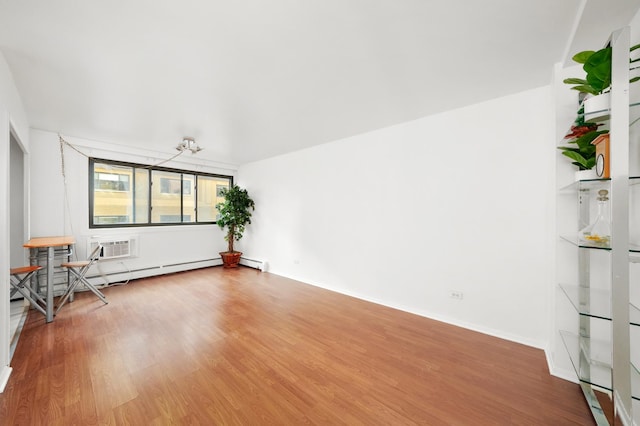 unfurnished living room featuring wood-type flooring and a wall unit AC