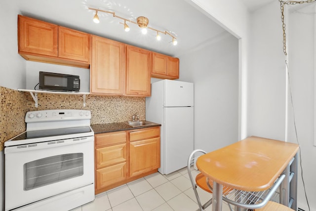 kitchen featuring sink, backsplash, white appliances, and light tile patterned flooring