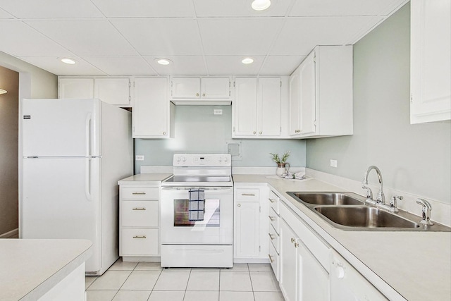 kitchen with light tile patterned flooring, a paneled ceiling, white cabinetry, sink, and white appliances