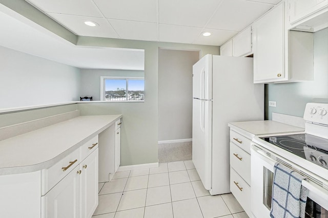 kitchen featuring white cabinetry, light tile patterned flooring, and white appliances