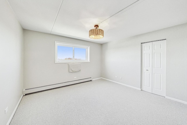 spare room with carpet floors and baseboard heating