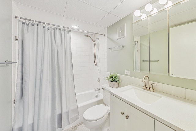 full bathroom with vanity, a paneled ceiling, shower / bathtub combination with curtain, and toilet