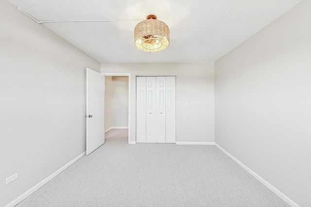 unfurnished bedroom featuring a closet and carpet flooring